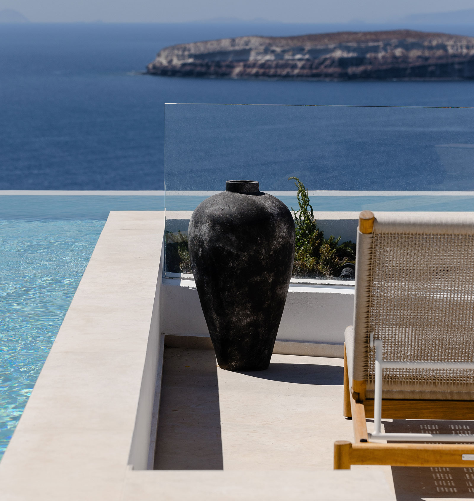 A modern amphora by the pool overlooking the sea at the luxurious Omna Caldera Suites in Santorini.