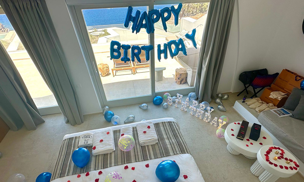 Party decorations in a bedroom at Omna Caldera, where you can explore the Santorini Suites Amenities